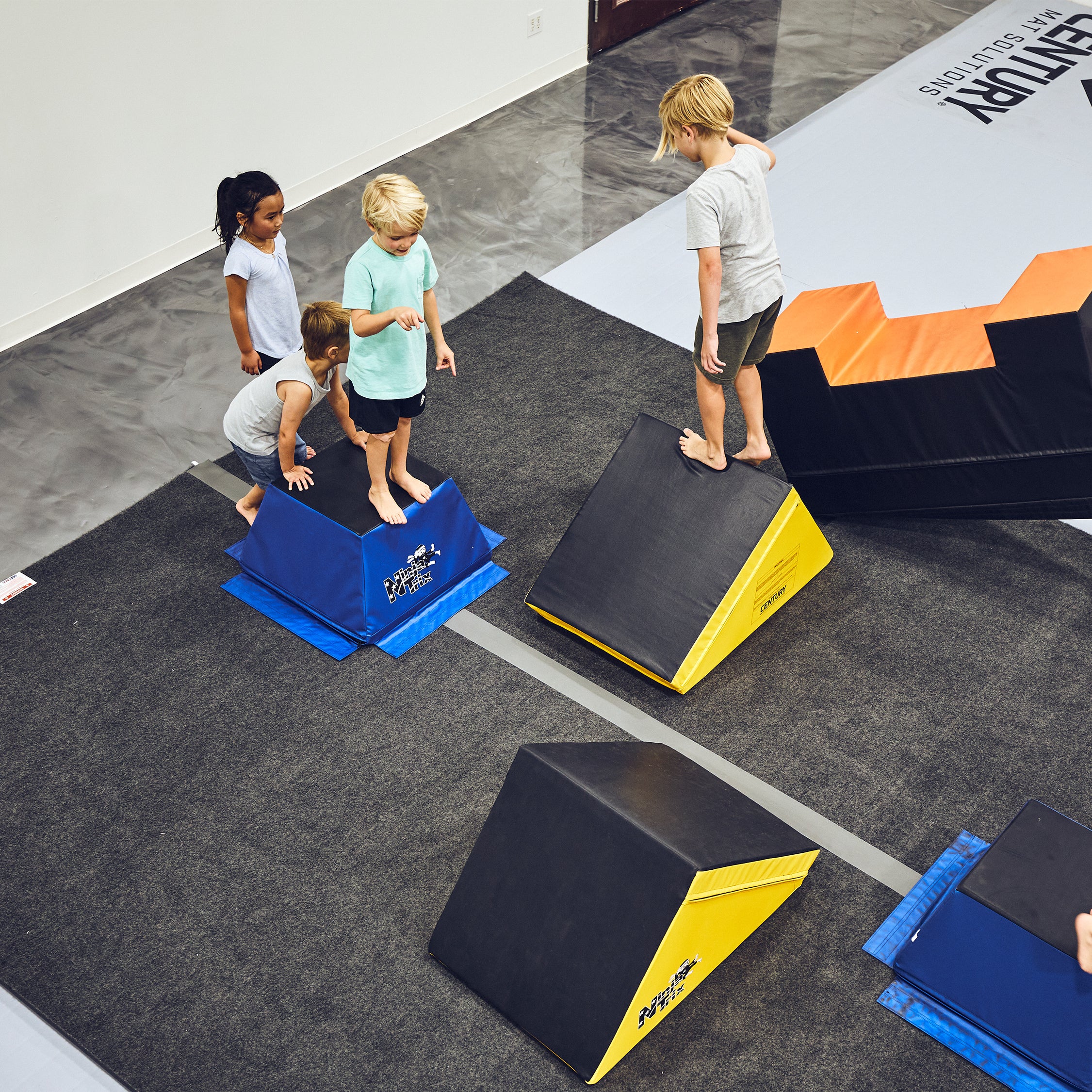 kids using obstacle course on professional flooring of carpet bonded foam