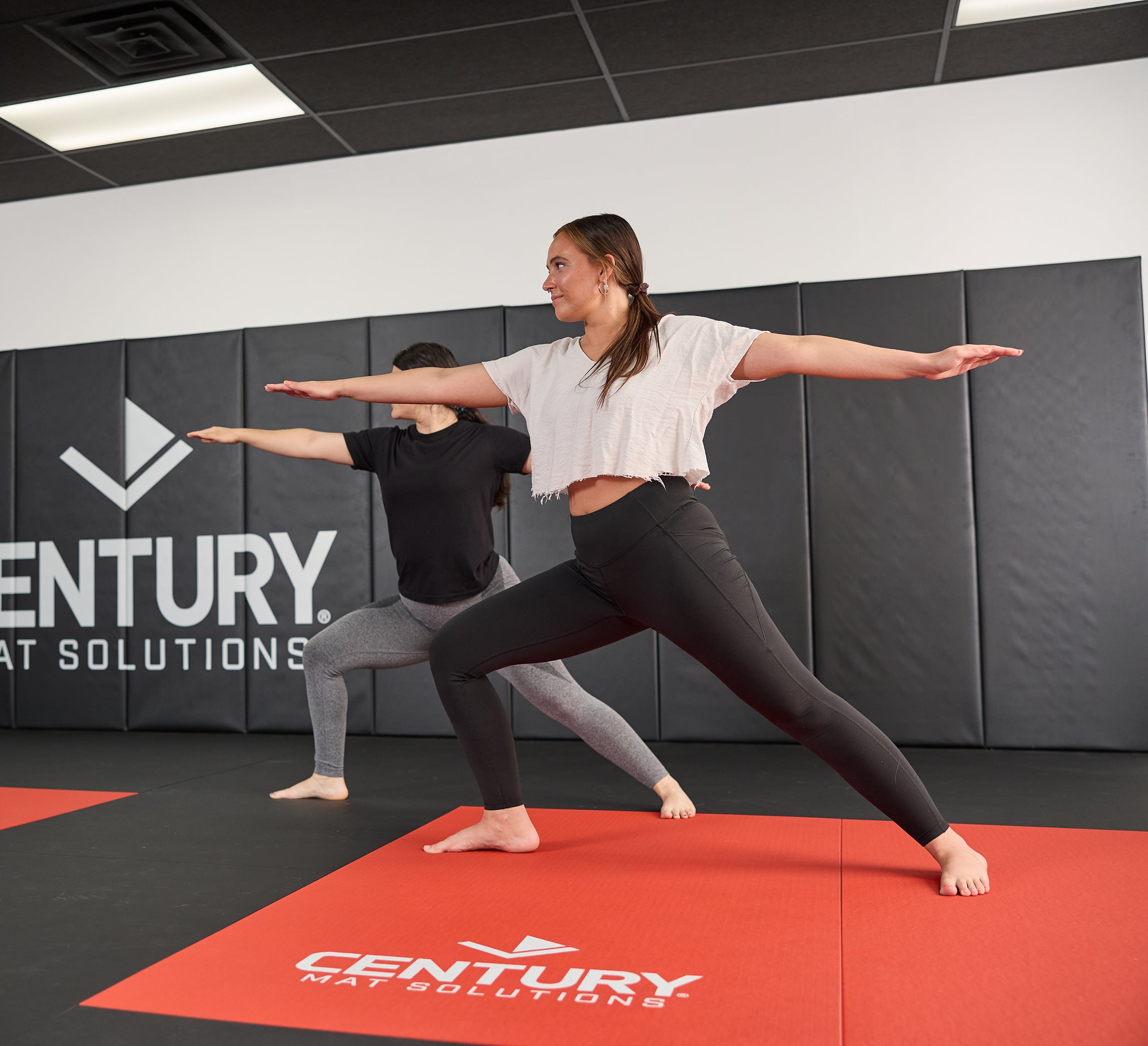 Two women posing on mat