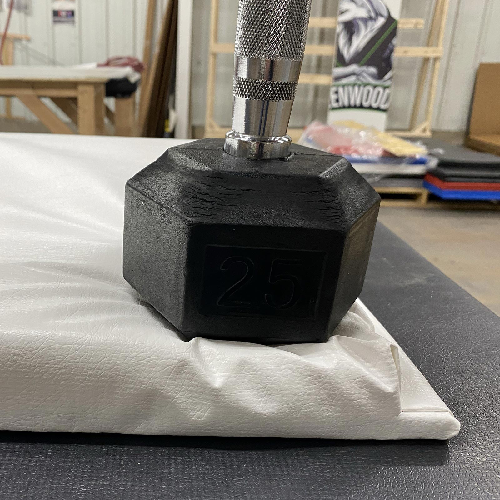 competitor wall pad with dumbell on it