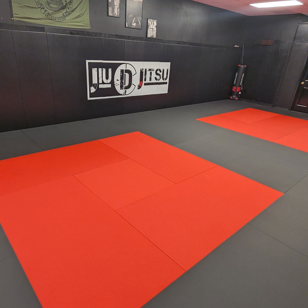 black and red wall pads and mats in a gym