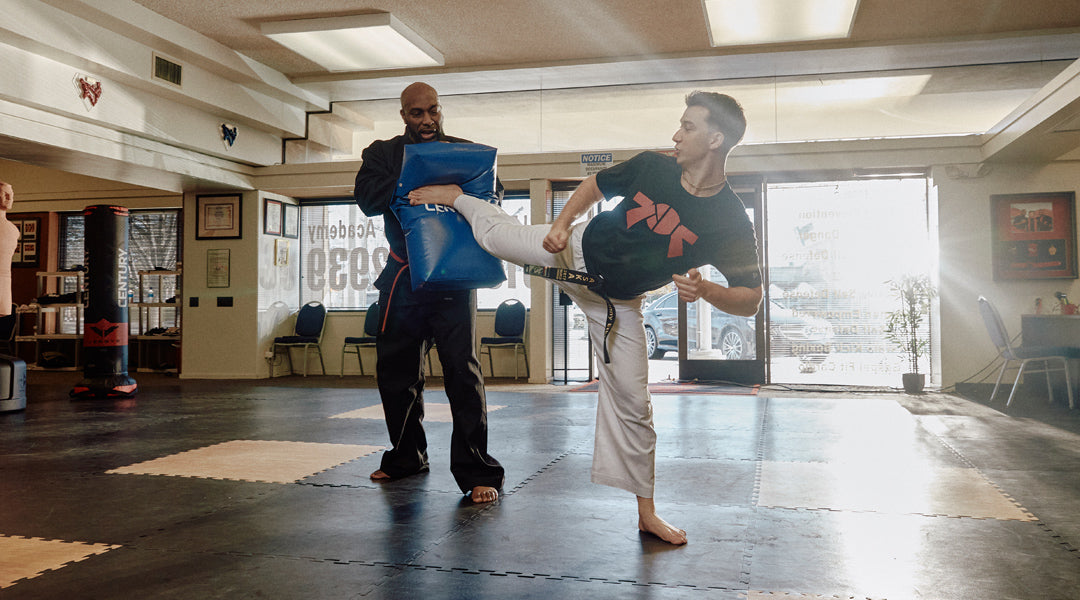 martial artists training on mats