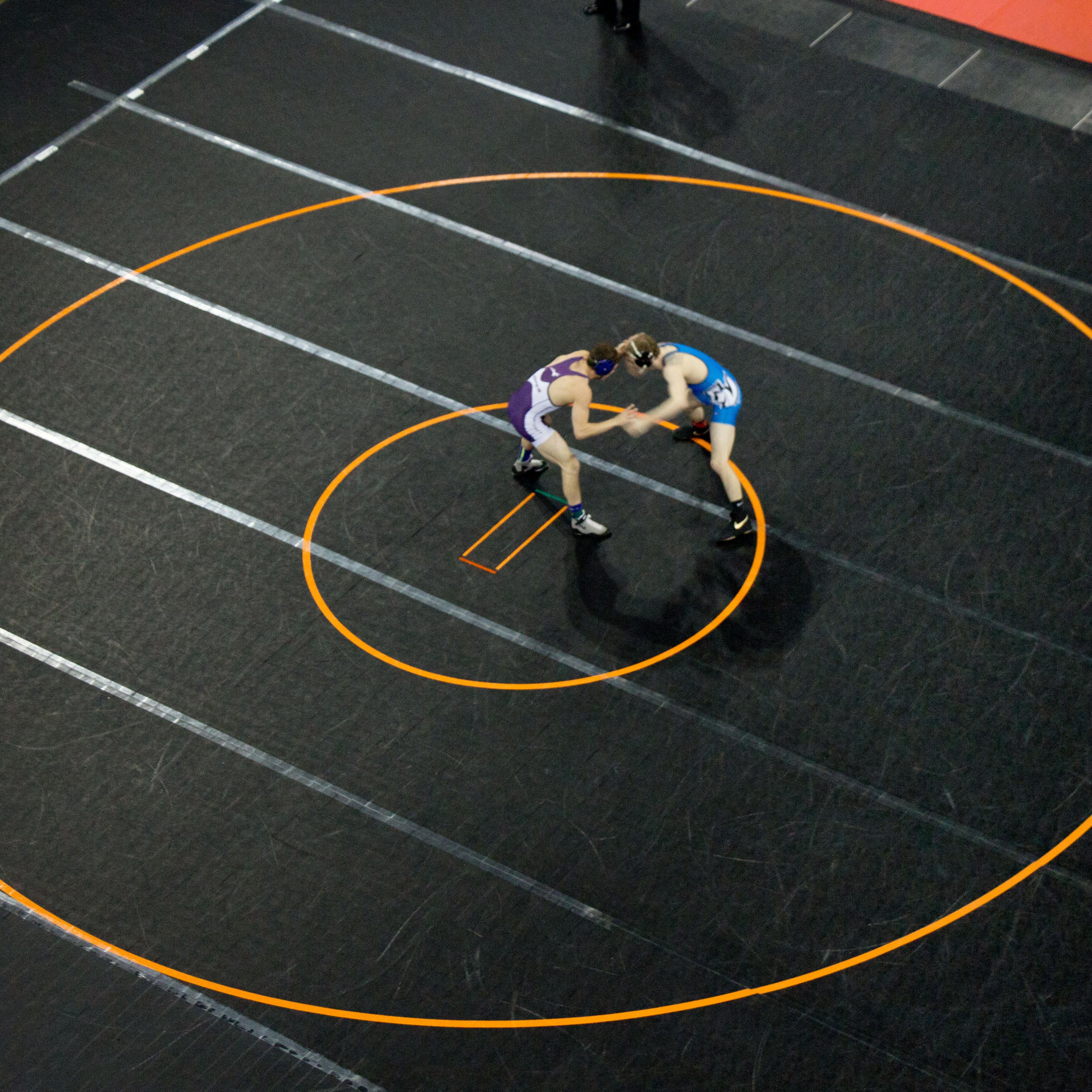 wrestlers in competition on mats