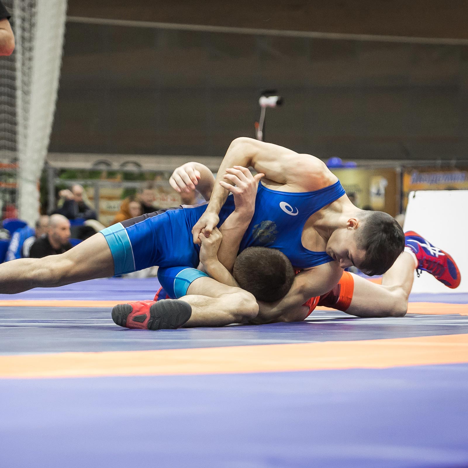 wrestlers competing on mats